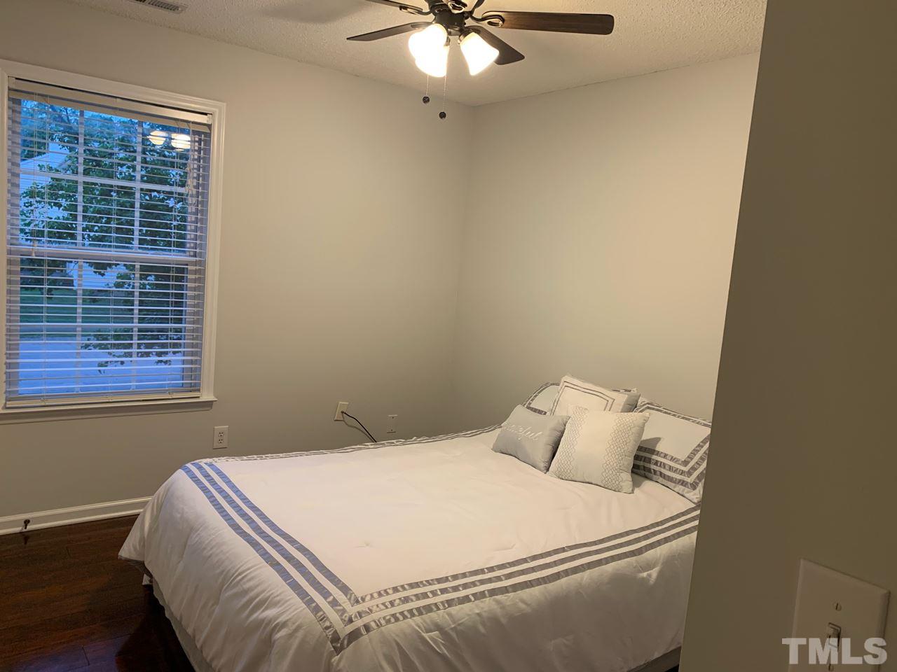 4516 Drewbridge Way Raleigh, NC 27604 - Photo 15 of 23 a bedroom with a bed and a window