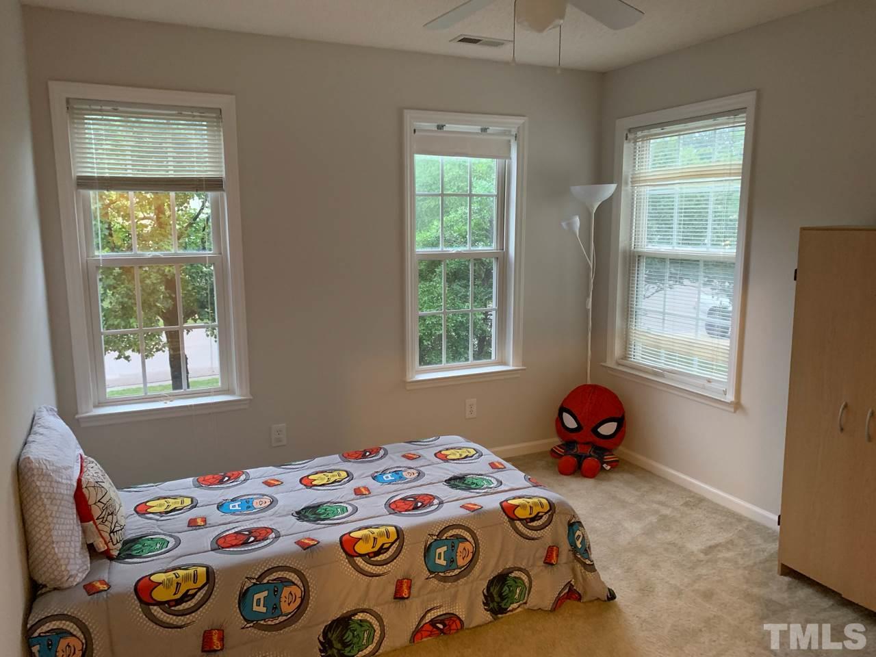 4516 Drewbridge Way Raleigh, NC 27604 - Photo 18 of 23 a bedroom with a bed and a window
