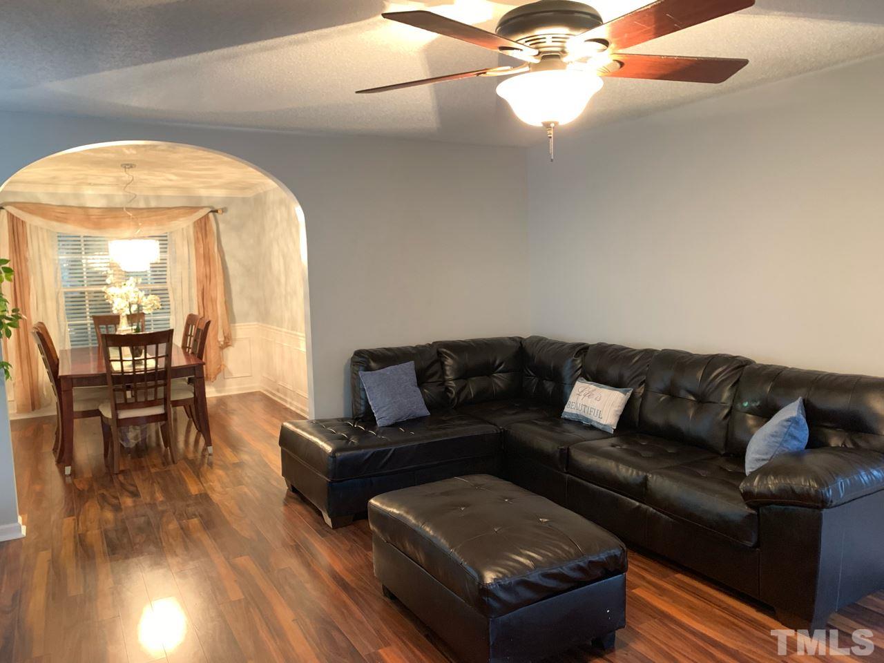 4516 Drewbridge Way Raleigh, NC 27604 - Photo 3 of 23 a living room with furniture and a large mirror next to a window