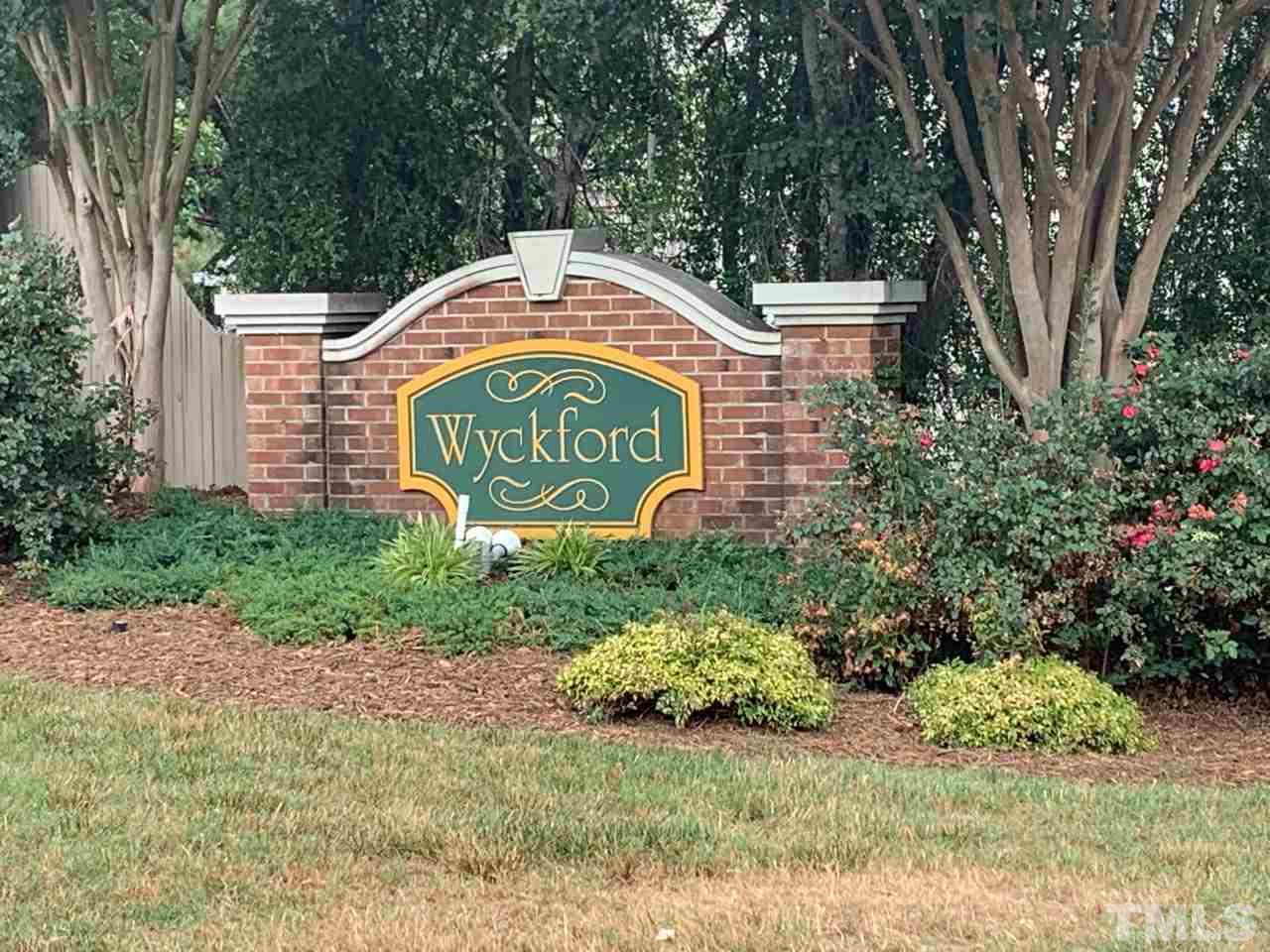4516 Drewbridge Way Raleigh, NC 27604 - Photo 22 of 23 a sign that is sitting on a brick wall
