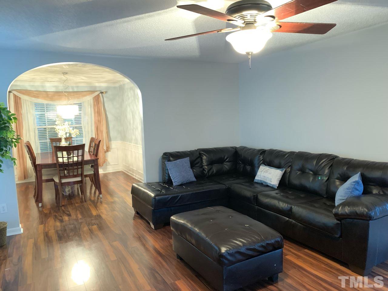 4516 Drewbridge Way Raleigh, NC 27604 - Photo 4 of 23 a living room with furniture and a large mirror next to a window