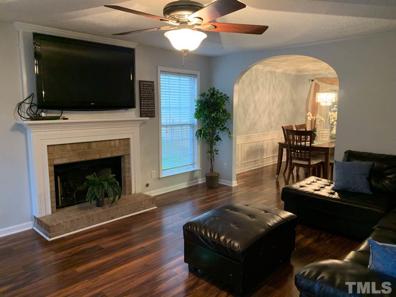 4516 Drewbridge Way Raleigh, NC 27604 - Photo 5 of 23 a living room with furniture and a fireplace