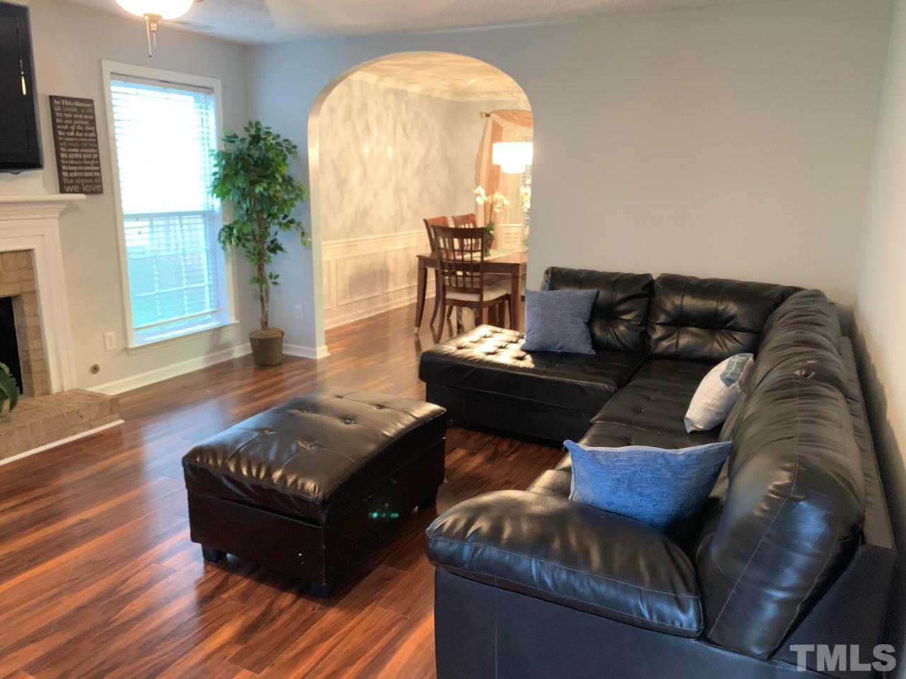 4516 Drewbridge Way Raleigh, NC 27604 - Photo 6 of 23 a living room with furniture and a fireplace