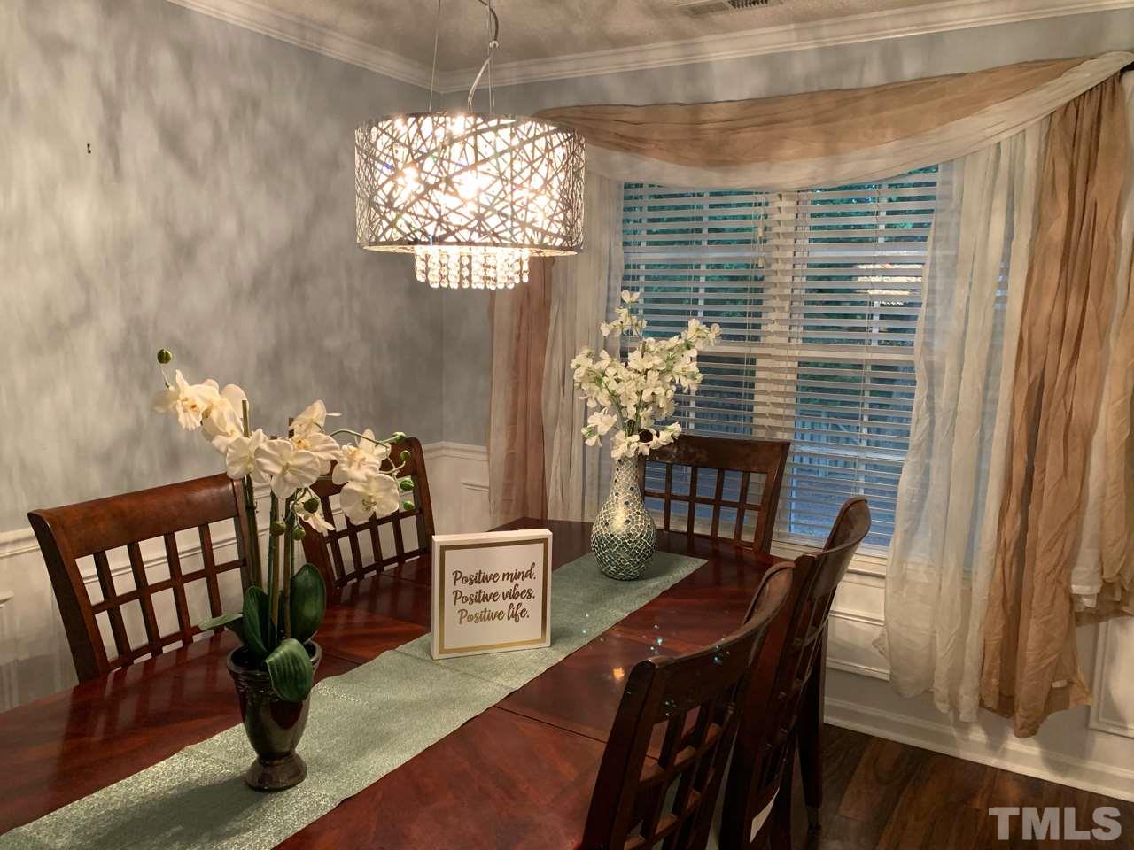 4516 Drewbridge Way Raleigh, NC 27604 - Photo 7 of 23 a view of a dining room with furniture window and wooden floor
