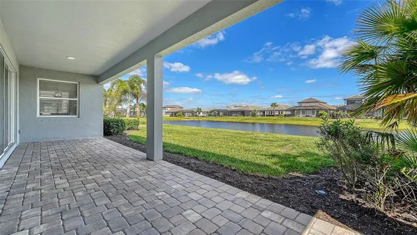 a front view of a house with a garden and patio