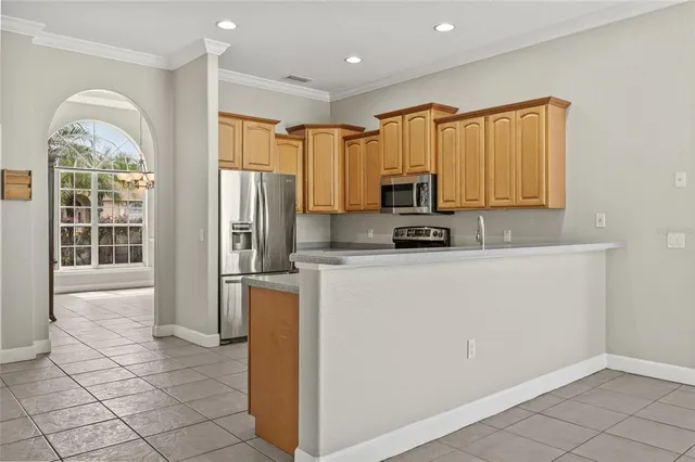 a living room with furniture chandelier and a mirror