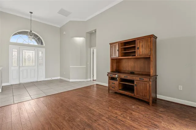 a view of a hallway with entryway and chandelier