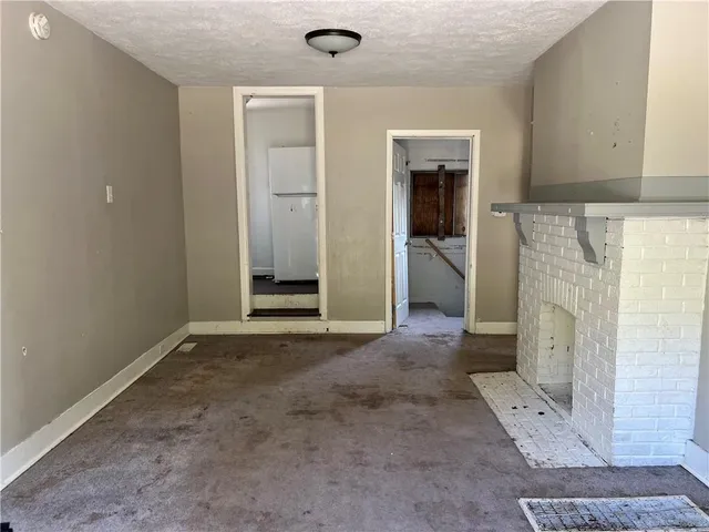 a kitchen with a sink a stove cabinets and a window
