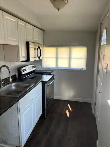 a kitchen with a refrigerator and a stove