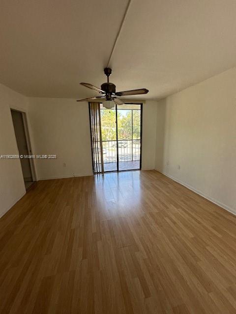 8015 Southwest 107th Avenue, Unit 201 Miami, FL 33173 - Photo 11 of 24 a view of an empty room with wooden floor and a window