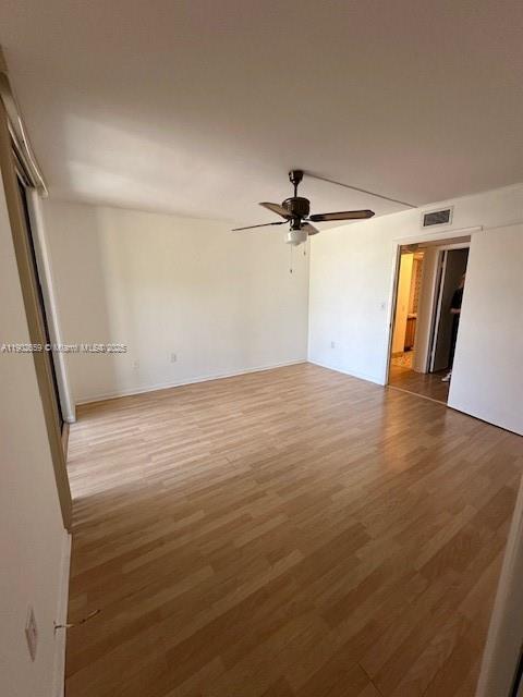 8015 Southwest 107th Avenue, Unit 201 Miami, FL 33173 - Photo 14 of 24 wooden floor in an empty room with a window