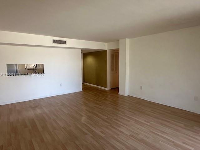 8015 Southwest 107th Avenue, Unit 201 Miami, FL 33173 - Photo 15 of 24 a view of an empty room with wooden floor