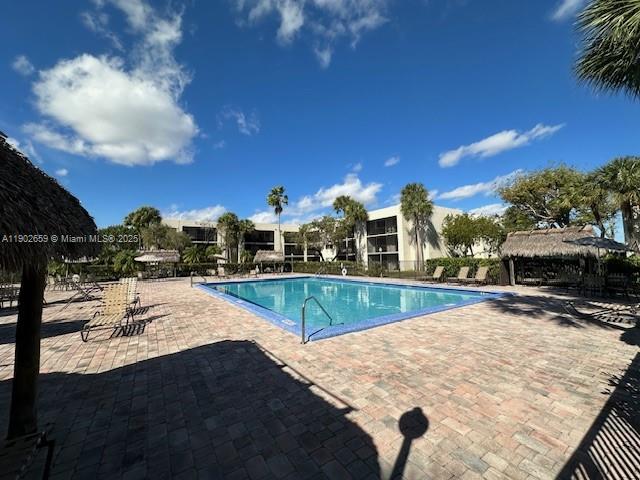 8015 Southwest 107th Avenue, Unit 201 Miami, FL 33173 - Photo 16 of 24 a view of a swimming pool with a lounge chairs