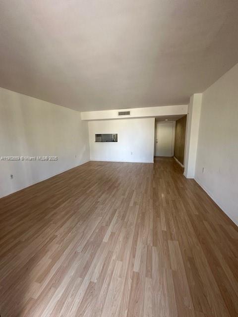 8015 Southwest 107th Avenue, Unit 201 Miami, FL 33173 - Photo 9 of 24 a view of empty room with wooden floor and fan
