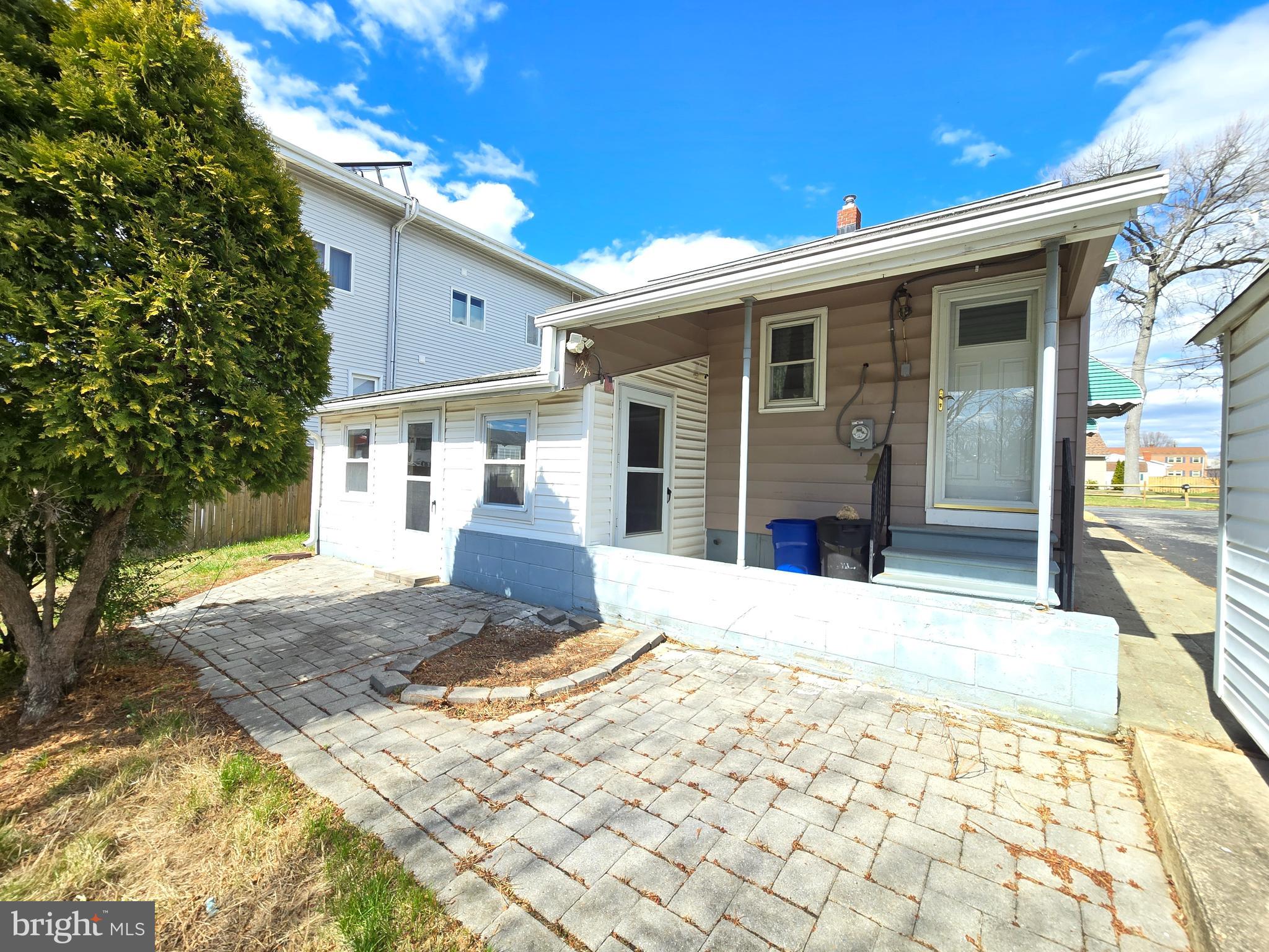 8193 Gumtree Drive Dundalk, MD 21222 - Photo 23 of 26 a front view of a house with a yard and garage