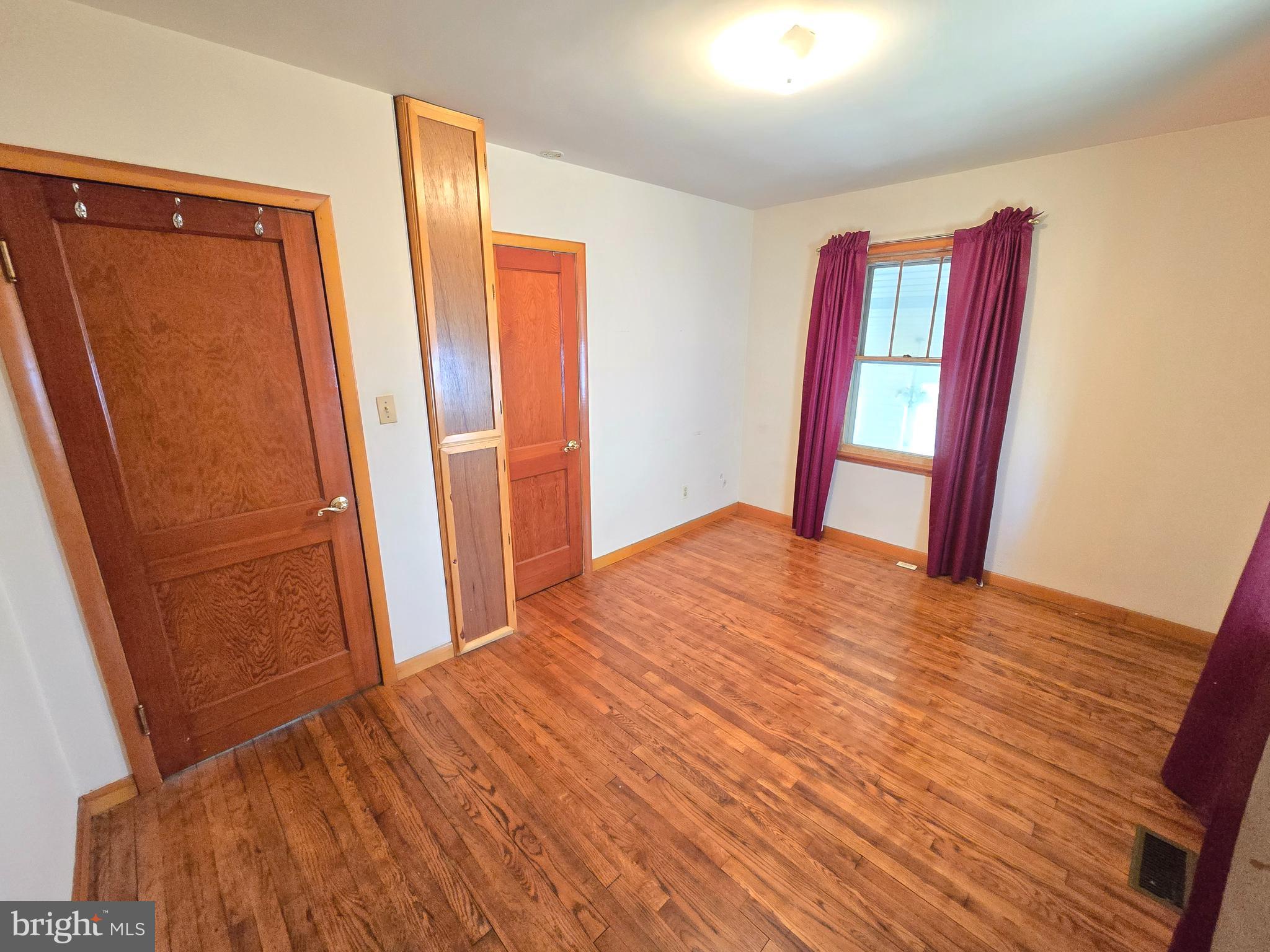 8193 Gumtree Drive Dundalk, MD 21222 - Photo 7 of 26 a view of empty room with wooden floor and fan