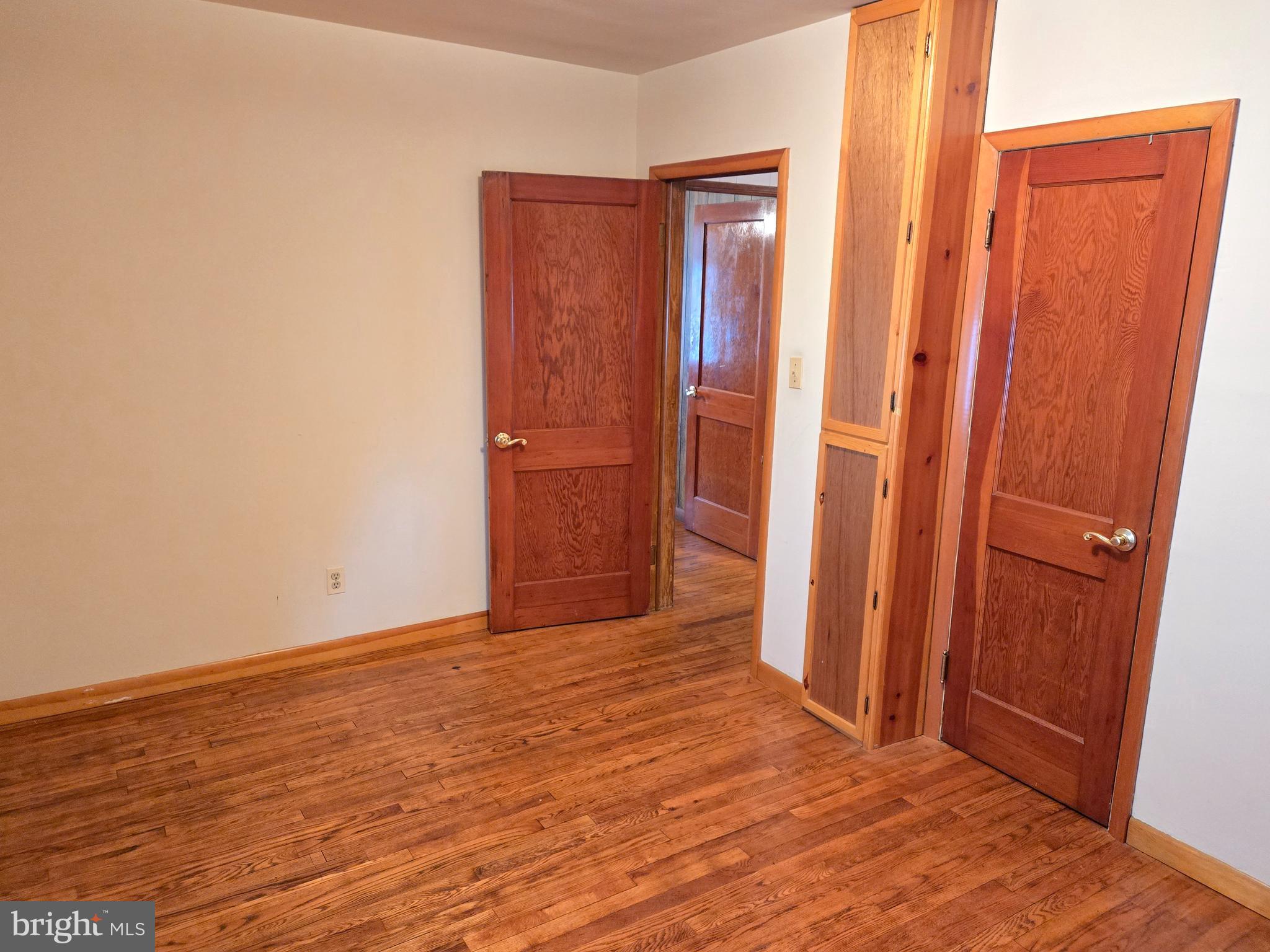 8193 Gumtree Drive Dundalk, MD 21222 - Photo 8 of 26 an empty room with wooden floor and a door