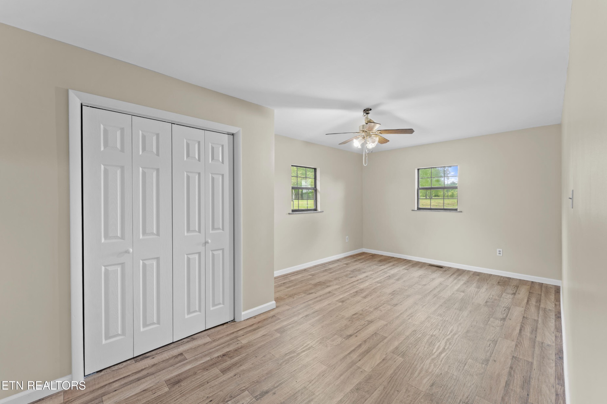 292 Buckner Road Philadelphia, TN 37846 - Photo 19 of 38 an empty room with wooden floor chandelier and windows
