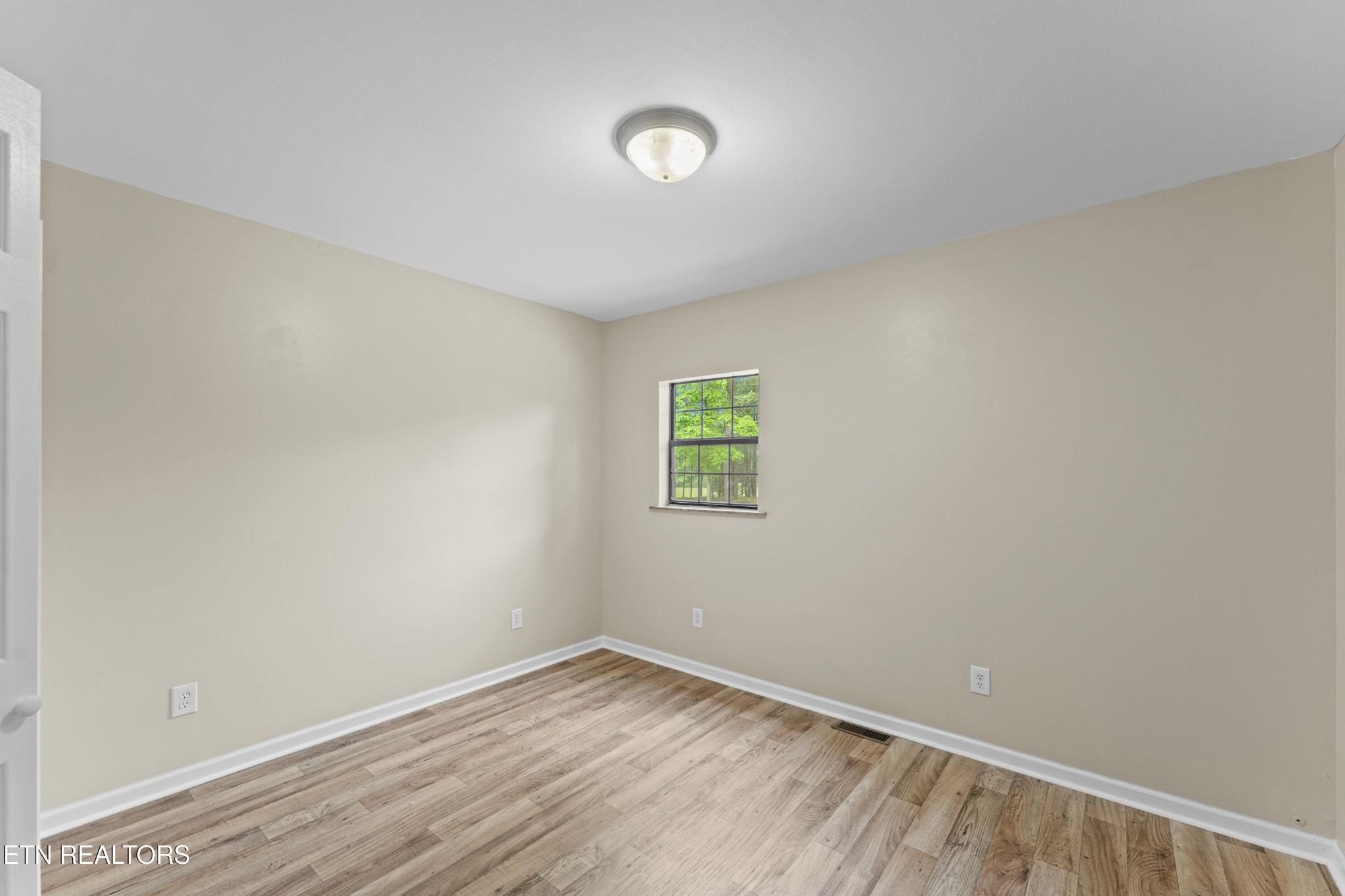 292 Buckner Road Philadelphia, TN 37846 - Photo 23 of 38 a view of an empty room with wooden floor and a window