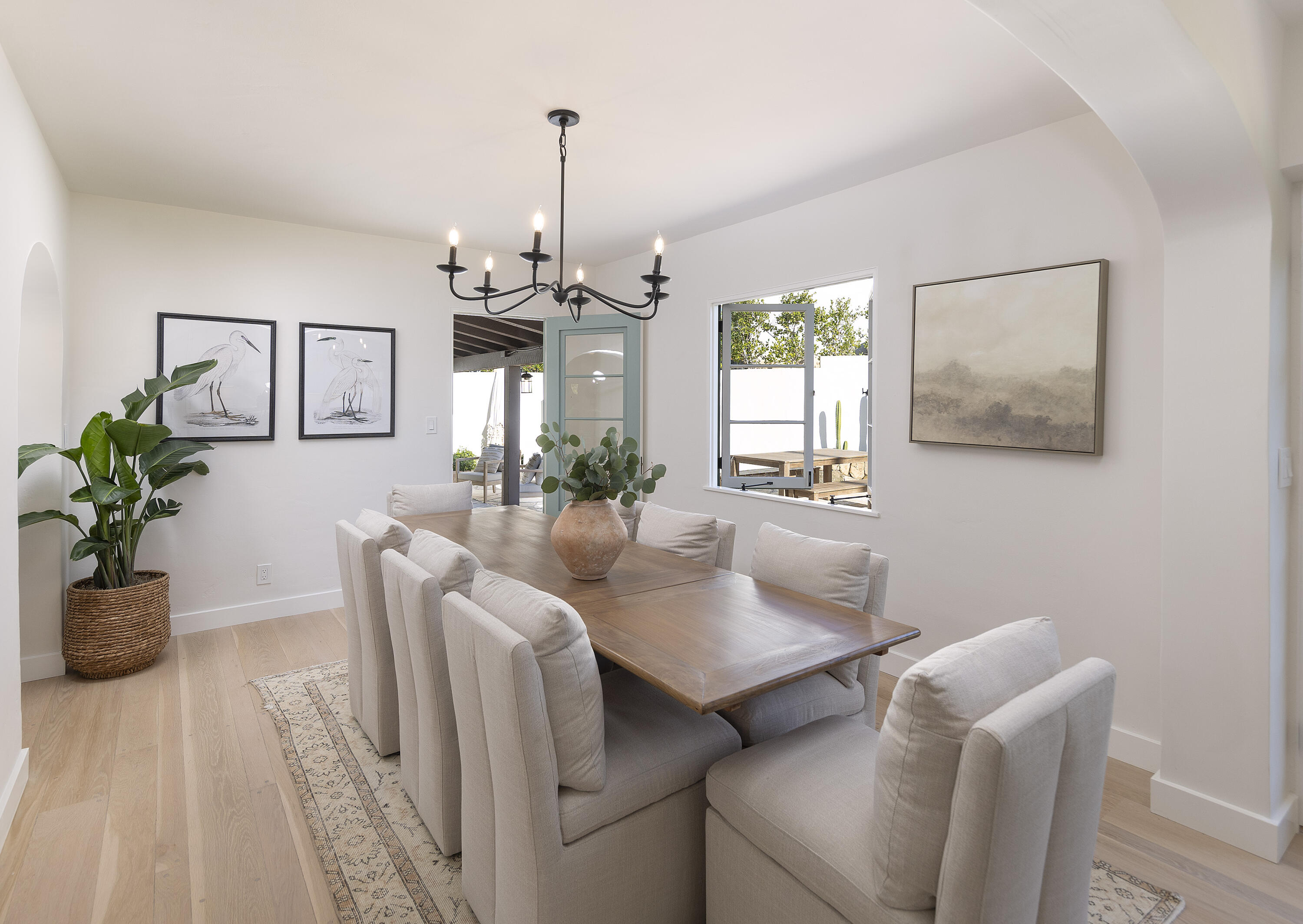 909 Chelham Way Montecito, CA 93108 - Photo 13 of 28 a view of a dining room with furniture and a potted plant