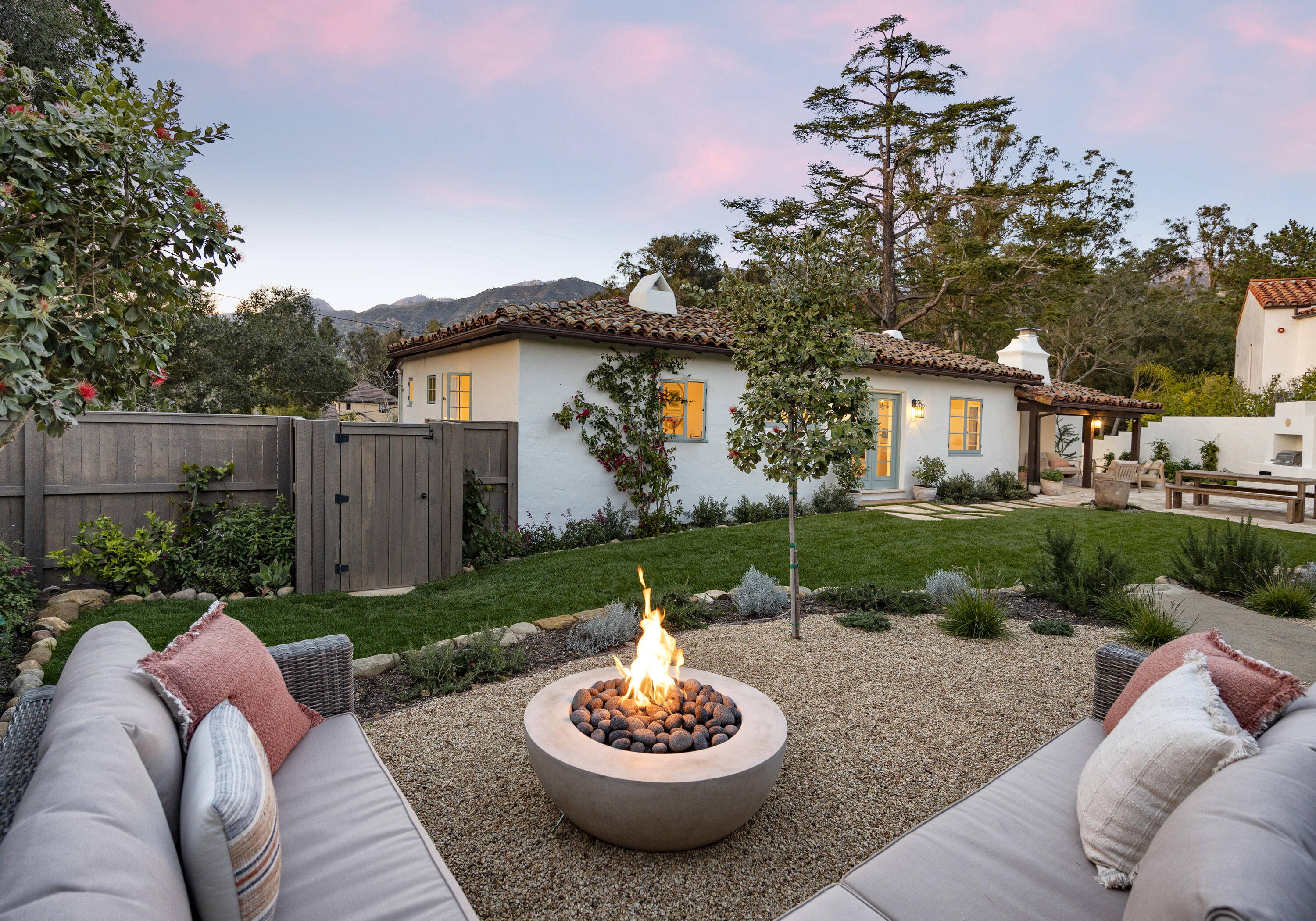 909 Chelham Way Montecito, CA 93108 - Photo 4 of 28 a view of a backyard with couches plants and large tree