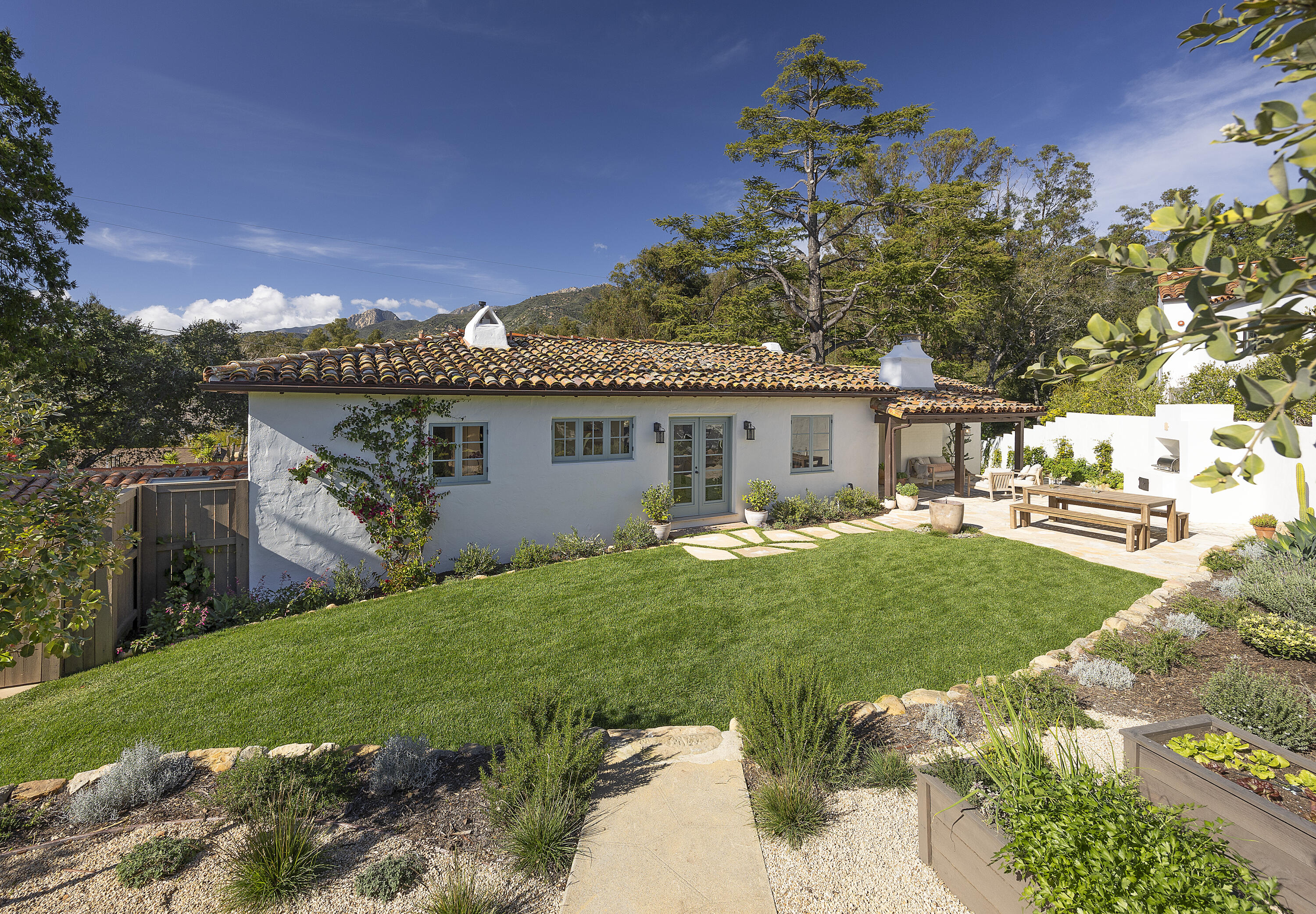 909 Chelham Way Montecito, CA 93108 - Photo 8 of 28 a front view of a house with a garden