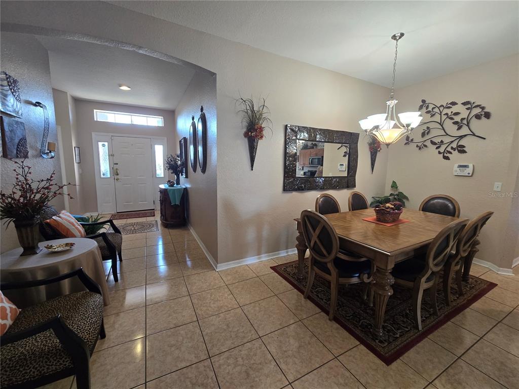 219 Cloverdale Road Winter Haven, FL 33884 - Photo 11 of 29 a view of a dining room with furniture and chandelier