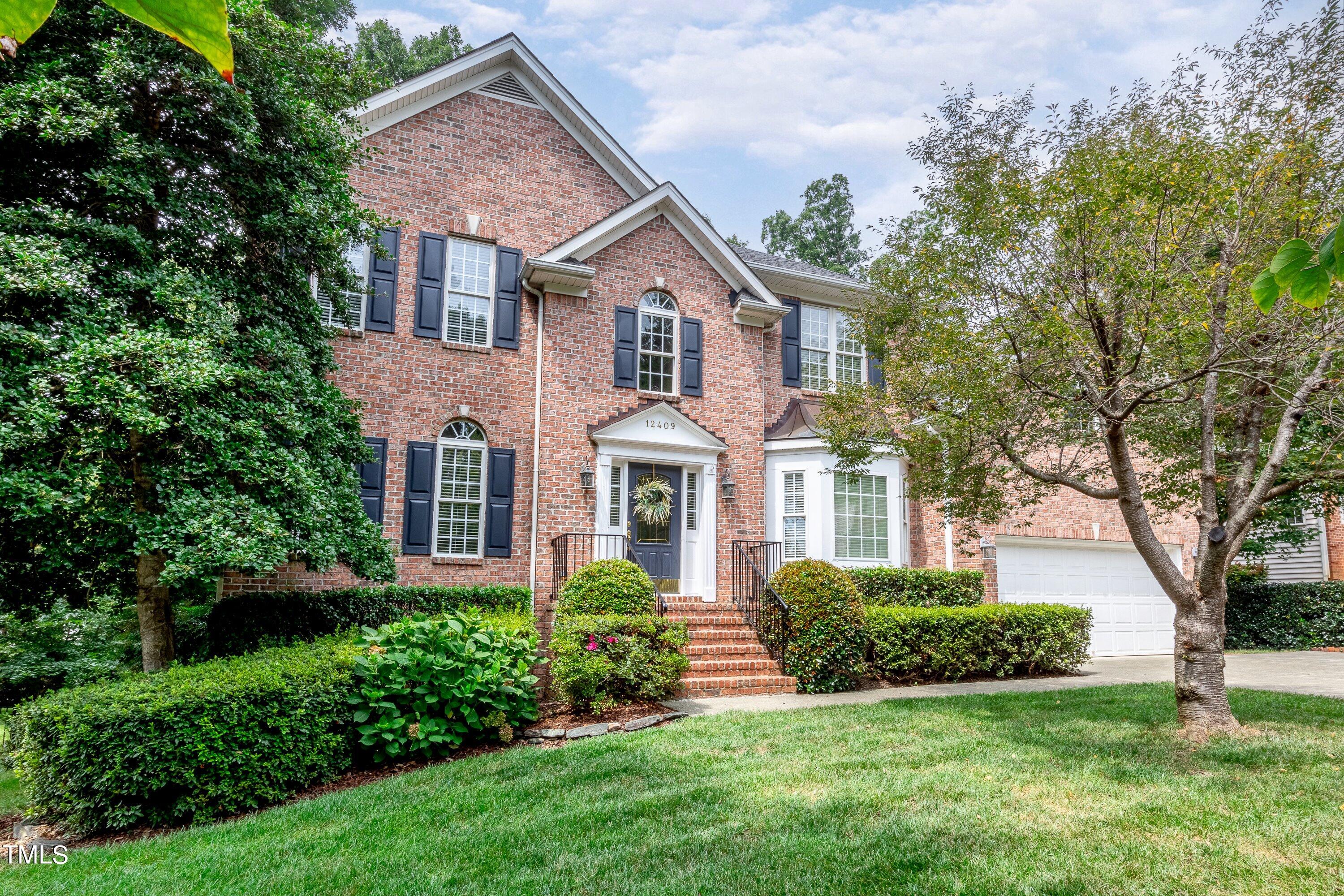 12409 Penrose Trail Raleigh, NC 27614 - Photo 1 of 43 a front view of a house with a yard and garage