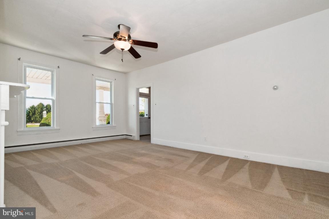 615 Hanover Pike Hampstead, MD 21074 - Photo 18 of 35 an empty room with windows and fan