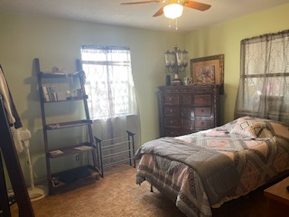 7371 Miller Creek Loop Johnson City, TX 78636 - Photo 14 of 37 a bedroom with a bed and a chandelier