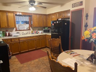 7371 Miller Creek Loop Johnson City, TX 78636 - Photo 36 of 37 a kitchen with a sink refrigerator and cabinets