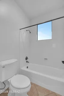 a bathroom with a double vanity sink toilet and mirror