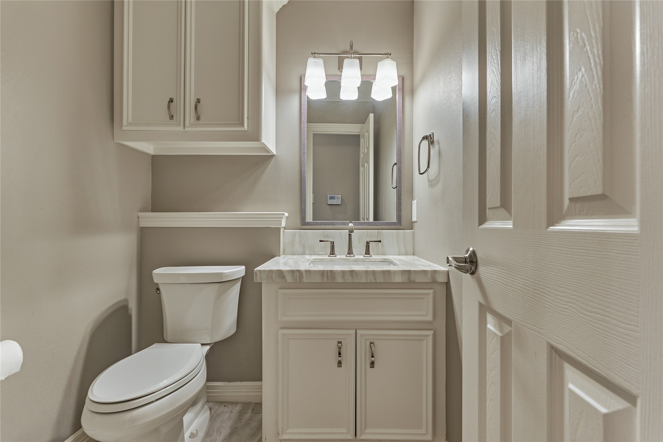 7 Gentry Oak Court Spring, TX 77381 - Photo 23 of 50 a bathroom with a toilet sink vanity and mirror