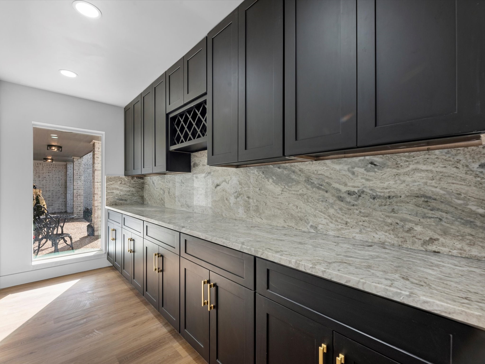 3514 La Costa Road Missouri City, TX 77459 - Photo 13 of 38 a kitchen with granite countertop cabinets a sink and wooden floor
