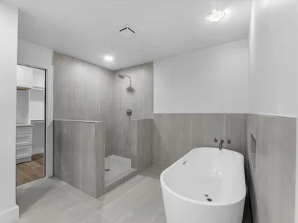 a white tub sitting in a bathroom