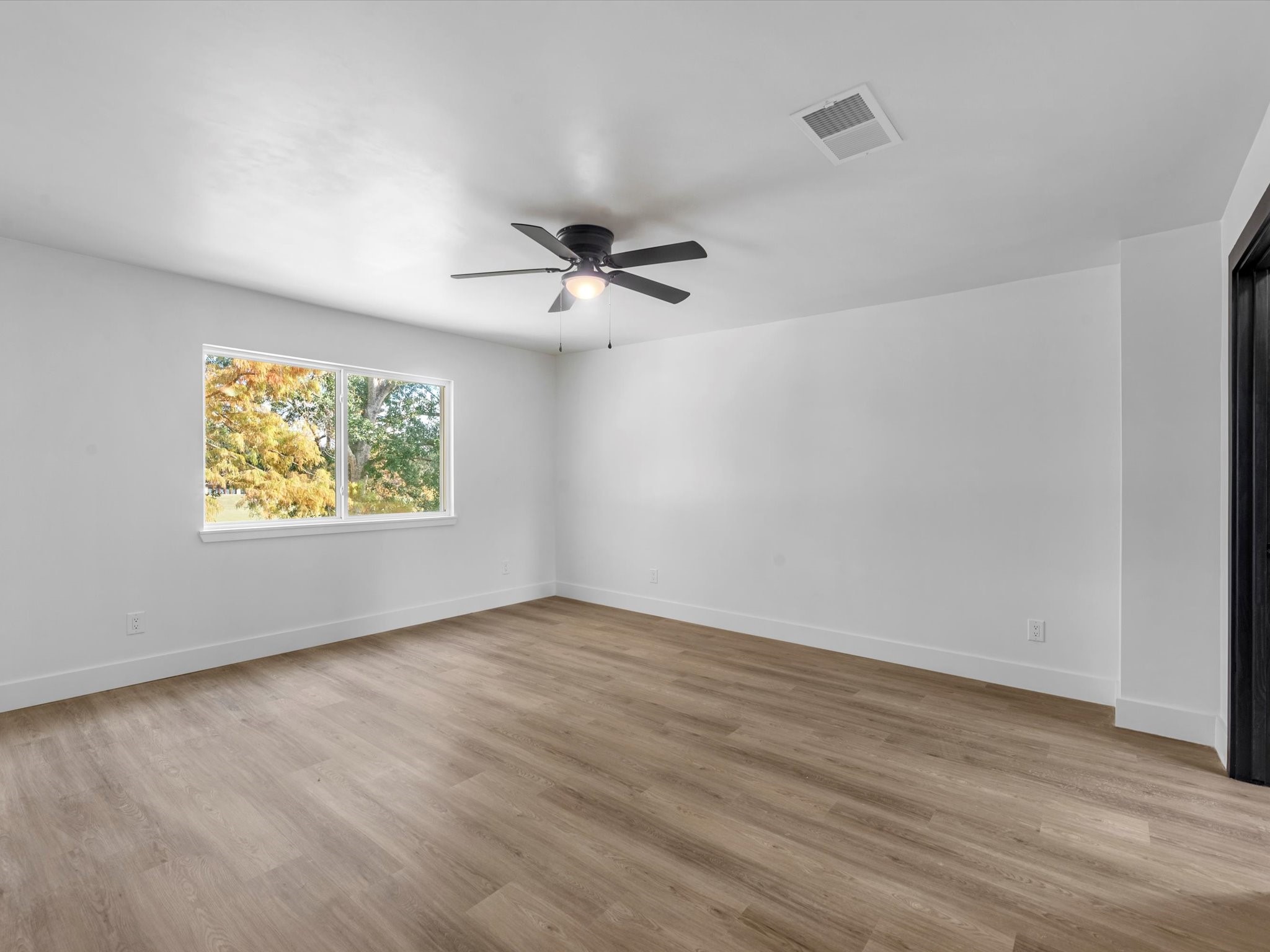 3514 La Costa Road Missouri City, TX 77459 - Photo 25 of 38 wooden floor in an empty room with a window