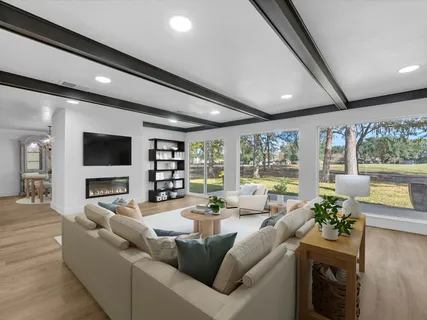 a dinning area with furniture and a large window