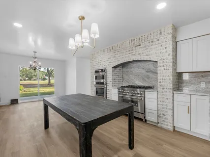 a stove top oven sitting inside of a kitchen