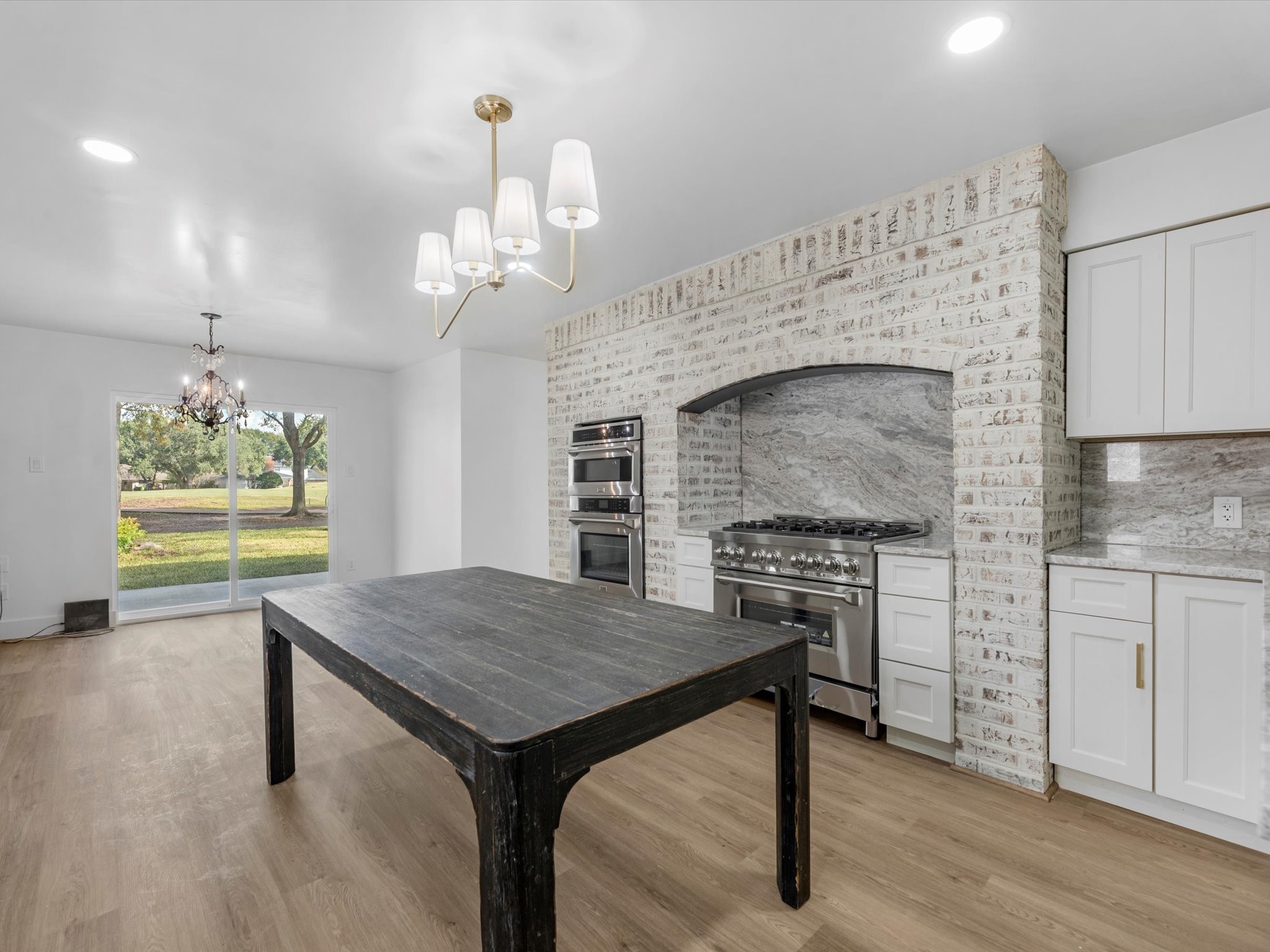 3514 La Costa Road Missouri City, TX 77459 - Photo 10 of 38 a kitchen with a stove and a wooden floor