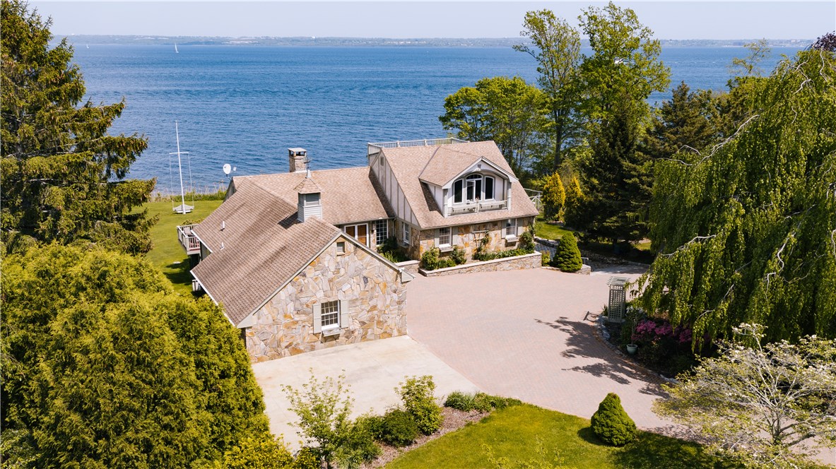 1046 East Shore Road Jamestown, RI 02835 - Photo 1 of 29 Aerial view of the home with bay in the background