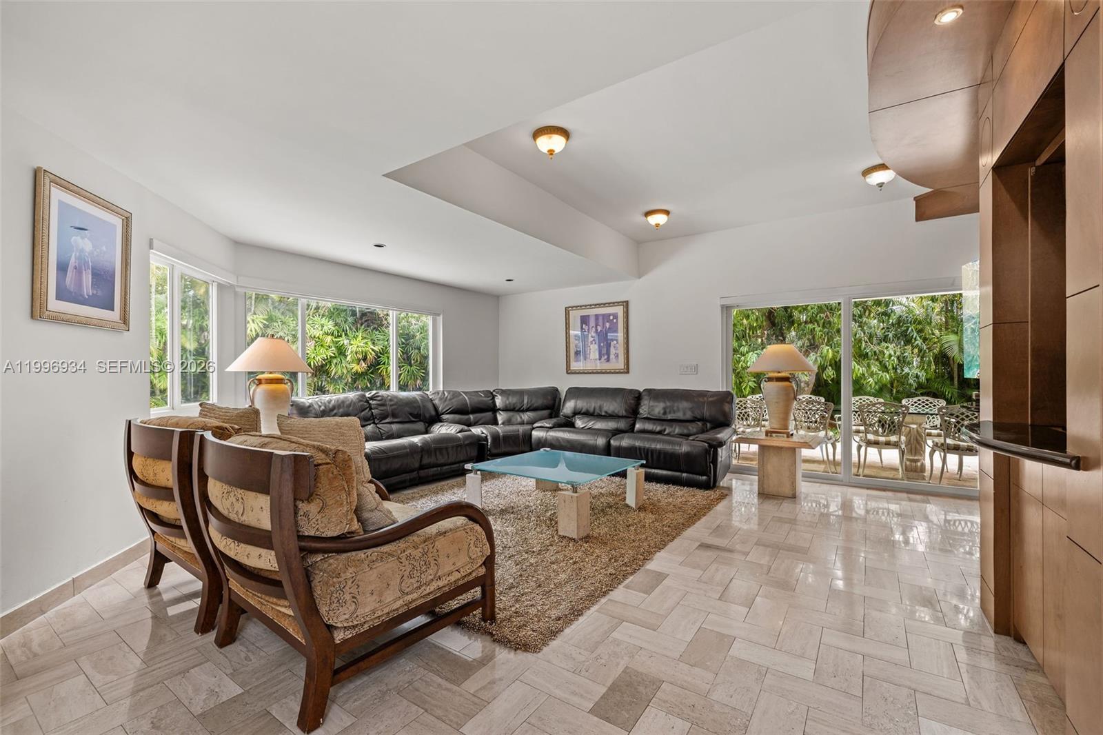 8450 Southwest 74th Terrace Miami, FL 33143 - Photo 17 of 54 a living room with furniture and a flat screen tv