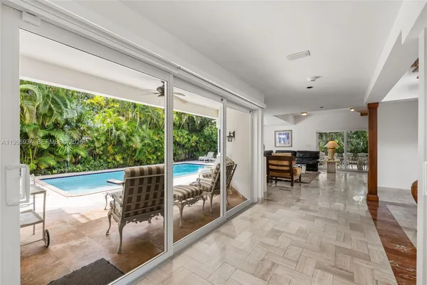 a view of a patio with swimming pool table and chairs