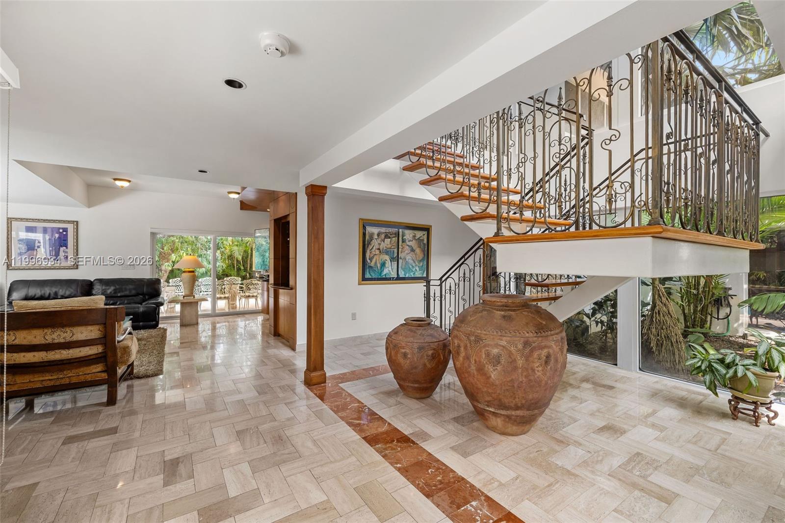 8450 Southwest 74th Terrace Miami, FL 33143 - Photo 20 of 54 a living room with furniture and a chandelier