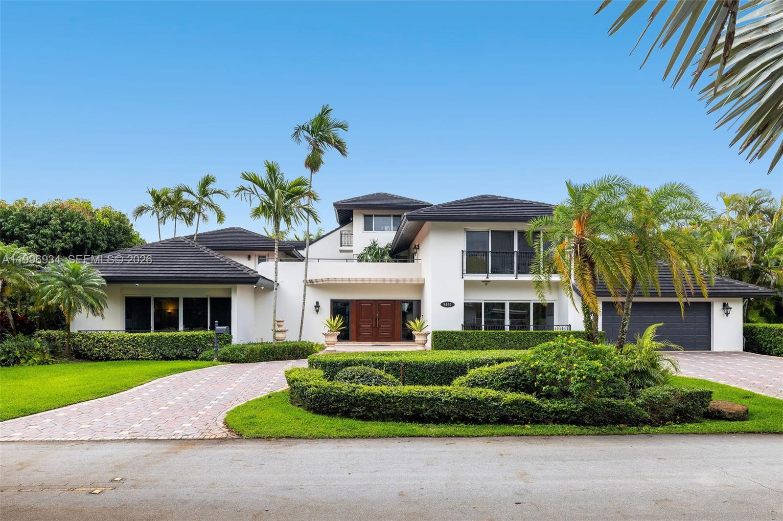 8450 Southwest 74th Terrace Miami, FL 33143 - Photo 2 of 54 a front view of a house with a yard and potted plants