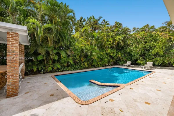a kitchen with a stove and a potted plant