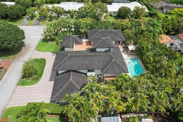an aerial view of a house with a yard and potted plants