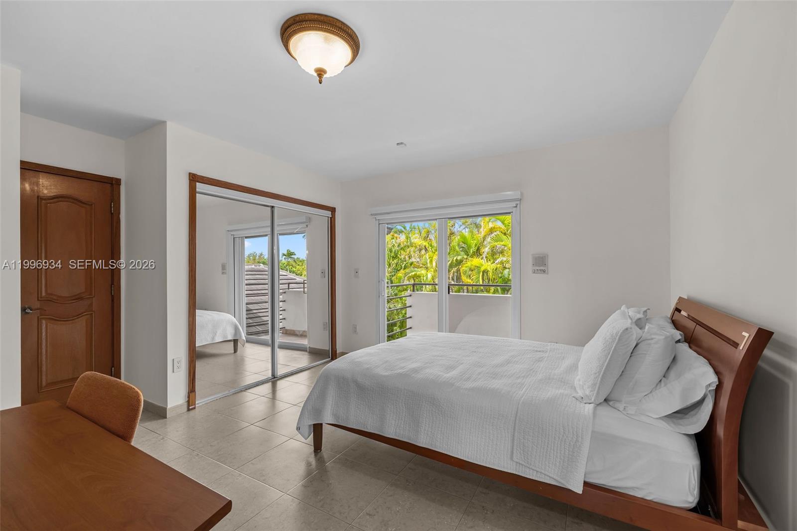 8450 Southwest 74th Terrace Miami, FL 33143 - Photo 42 of 54 a bedroom with a bed and sliding window