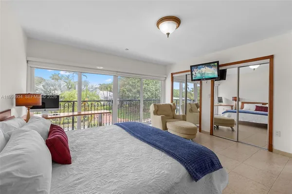 a view of a livingroom with workspace and a window