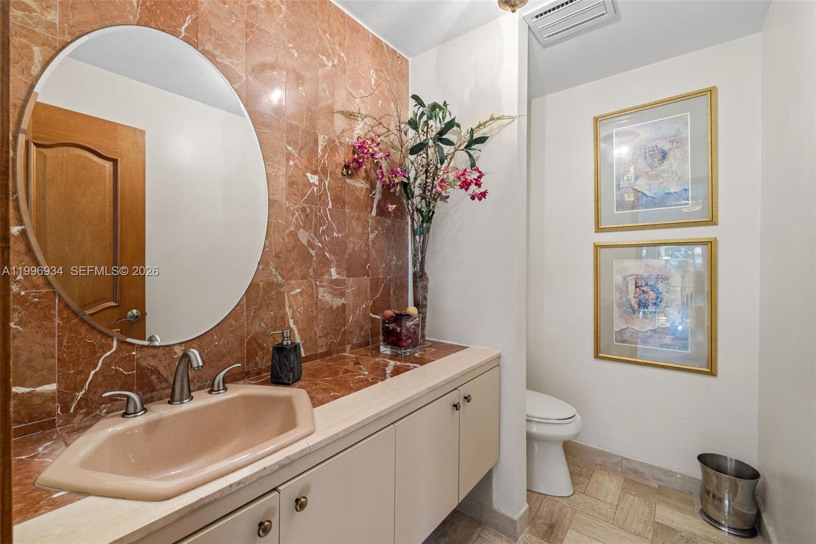 8450 Southwest 74th Terrace Miami, FL 33143 - Photo 48 of 54 a bathroom with a toilet sink and mirror