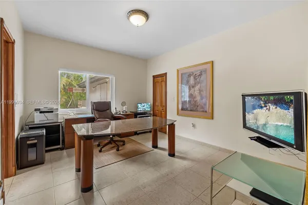 a front view of a house with a yard and potted plants